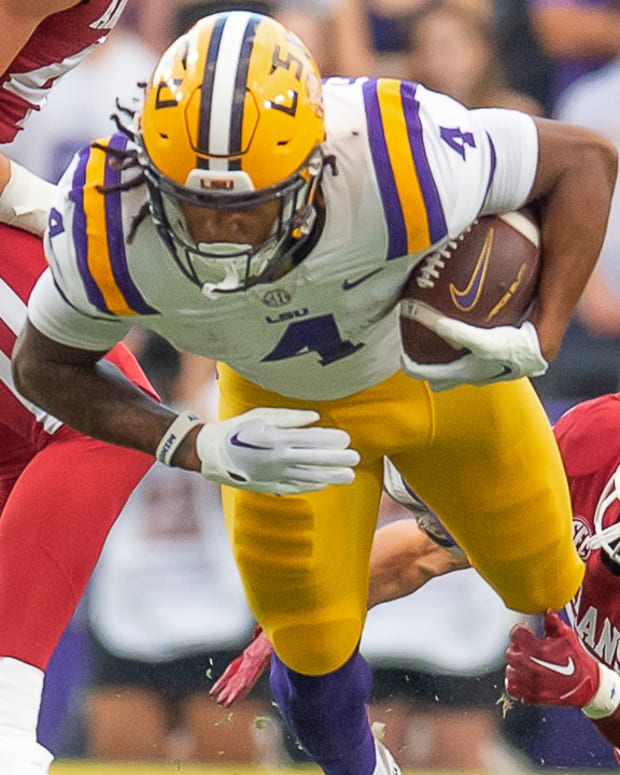 Razorbacks cornerback Hudson Clark tries to catch Brian Thomas Jr.